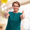 portrait of a mature woman with thumbs up portrait of a mature woman with thumbs up